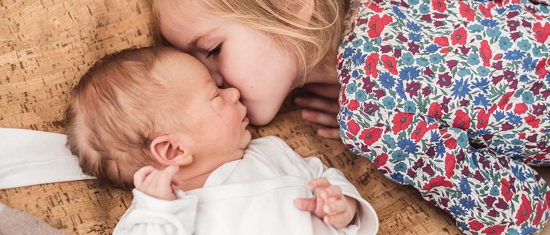 little girl with new born