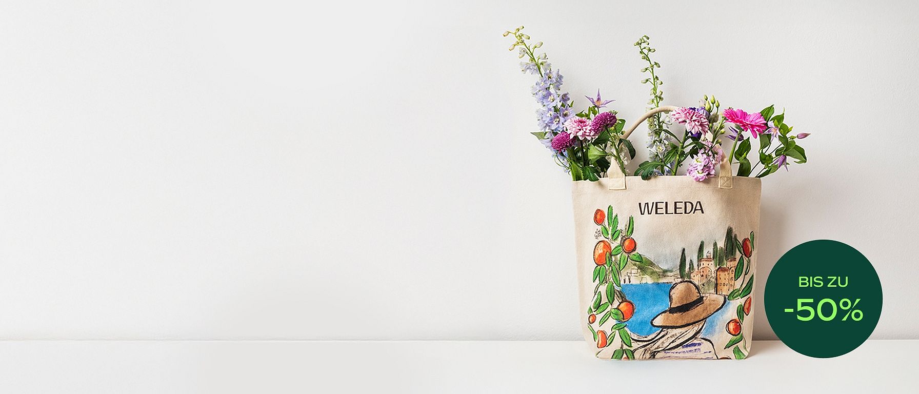 Strandtasche mit maritimem Design und Weleda-Schriftzug, gefüllt mit Blumen