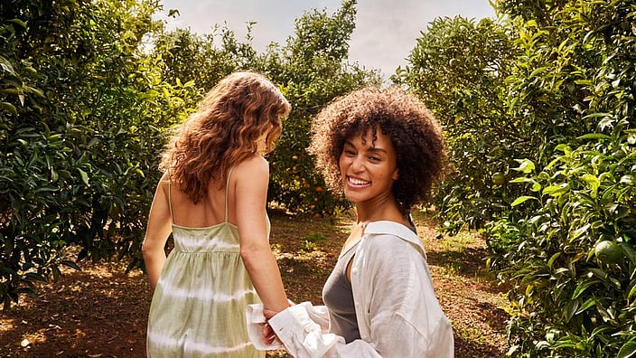 Zwei Frauen gehen durch den Garten