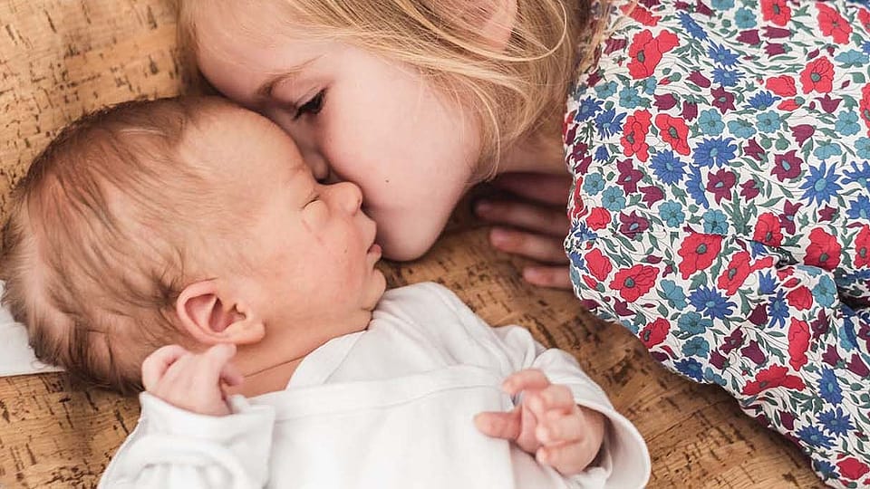 little girl with new born