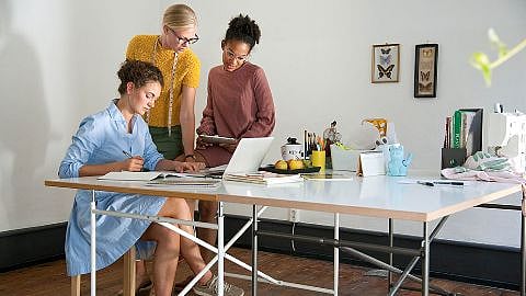 trois femmes travaillent au bureau