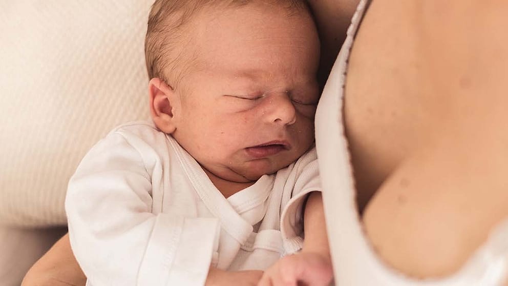 baby sleeps close to mum